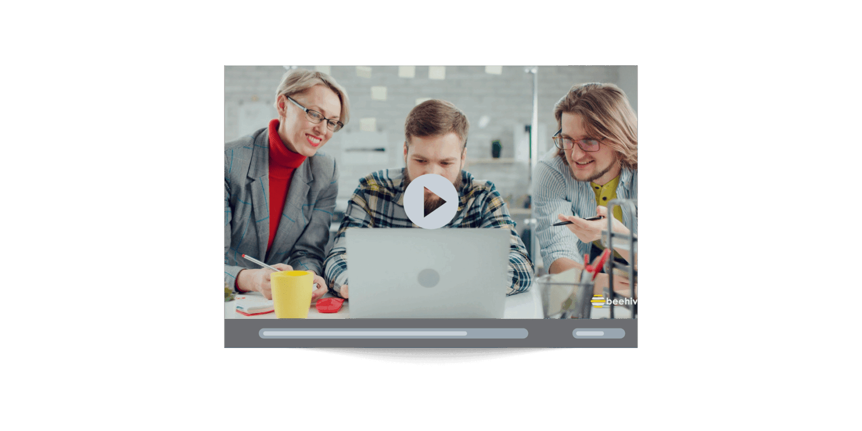 Still frame from Beehive’s corporate video showing a collaborative team working on a laptop, highlighting company culture and creative teamwork.